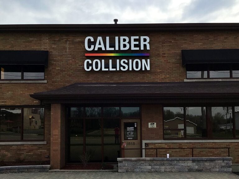 Channel letter sign for Caliber Collision in Joliet, IL, illuminated at night
