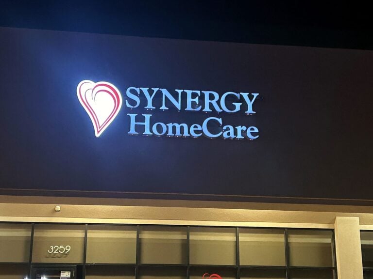 Channel letter sign for Synergy HomeCare in Springfield, IL, illuminated at night
