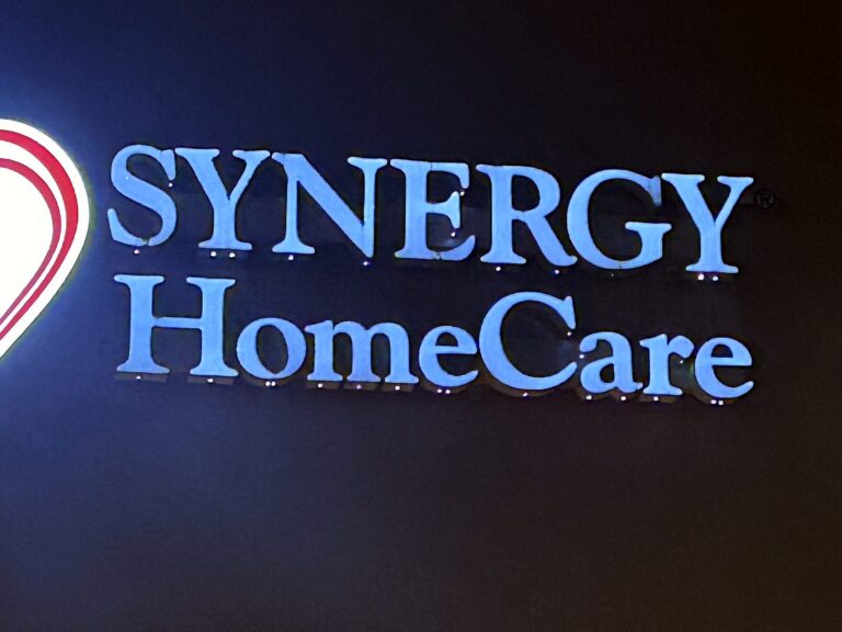Channel letter sign for Synergy HomeCare in Springfield, IL, illuminated at night – view 2