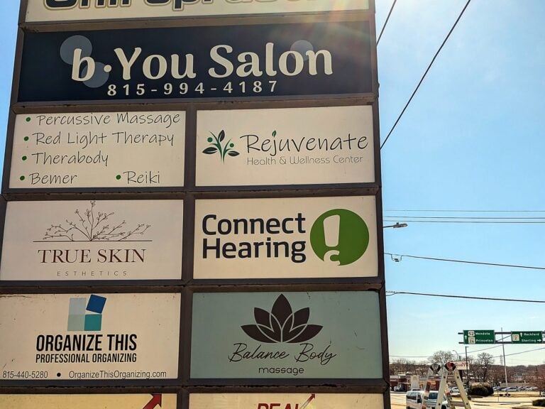 Signature Signs installation crew installing the b.You Salon sign in Dixon, IL