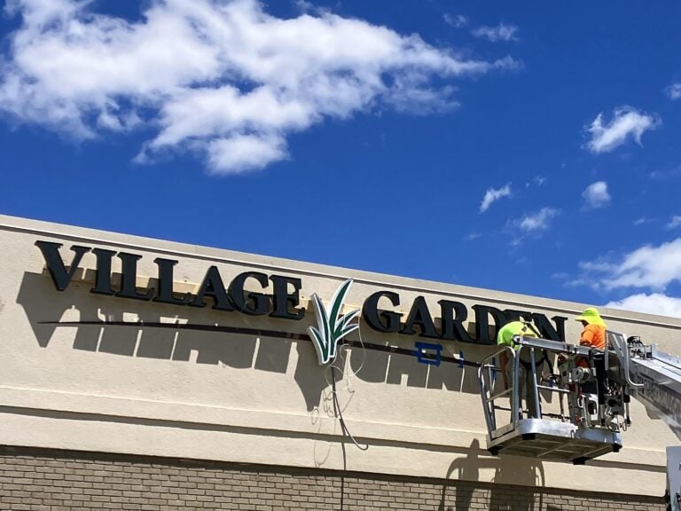 Signature Signs installation crew installing the Village Garden sign in Mt. Zion, IL