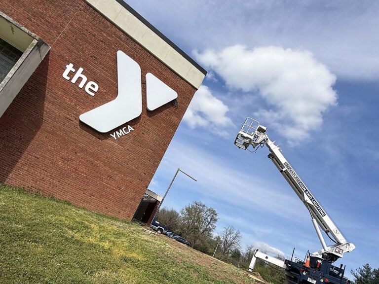 Signature Signs installation crew installing the YMCA sign in Jacksonville, IL